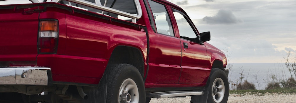 A red truck facing the horizon in East Texas.