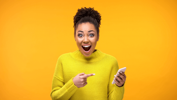 woman pointing at phone woman pointing at phone
